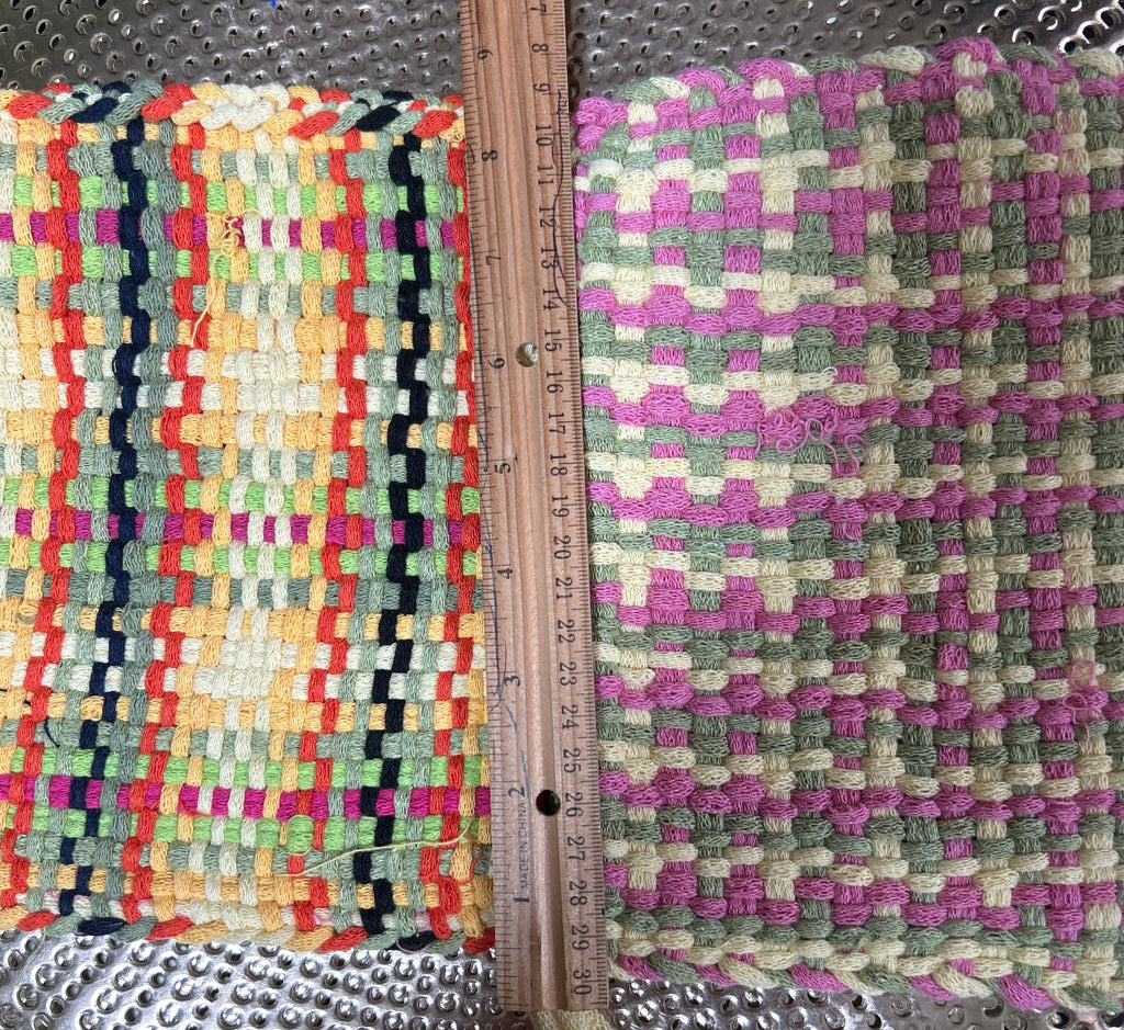 Two woven mats with different patterns and colors on a metallic surface.