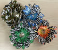 Decorative flowers with zebra print petals on a green textured background