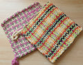 Colorful woven bag on a textured surface with a blurred background